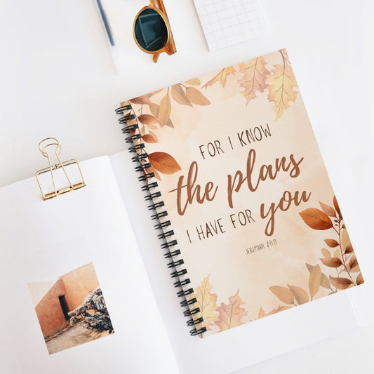 Notebook with floral design and text on a white surface