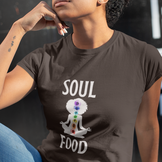 Person wearing a brown t-shirt with 'Soul Food' design featuring a person meditating with chakra colors.