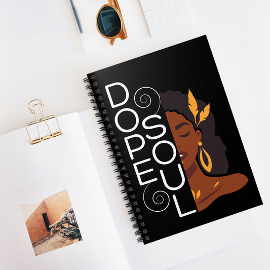Notebook with a design of a woman's face and 'Dope Soul' text on a white surface.