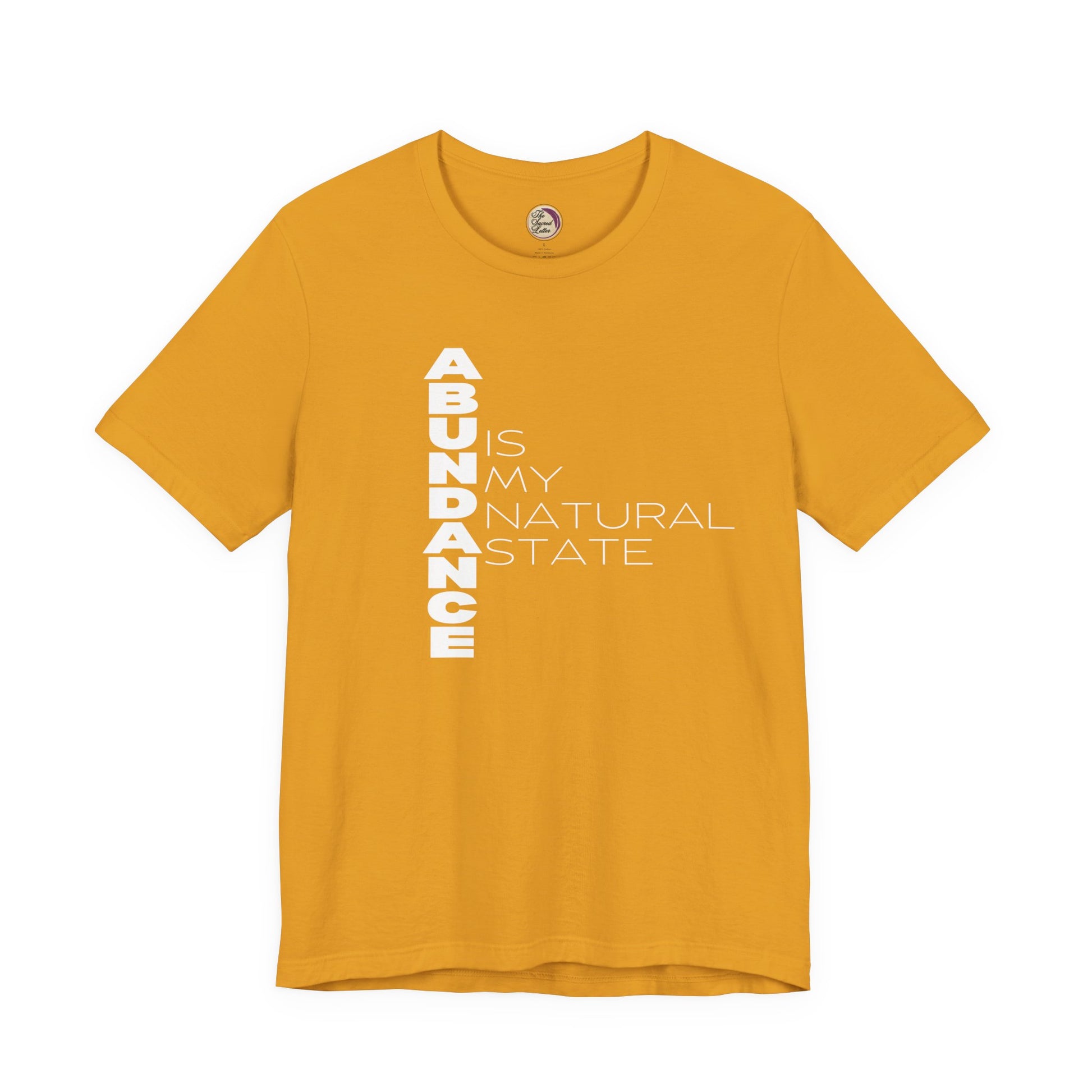 Yellow t-shirt with white text 'ABUNDANCE IS MY NATURAL STATE' on a white background